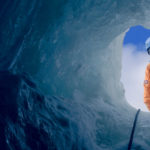 Looking up to a BAS Field assistant through a deep hole in the ice