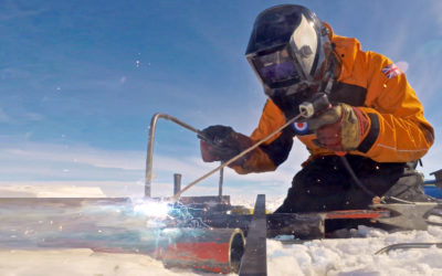 A person welding in an icy landscape