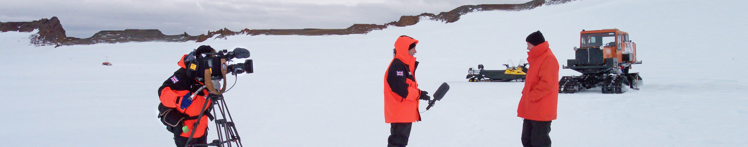 A film crew interviewing a man in an icy landscape