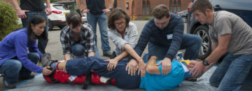 A group of people sitting on the ground.