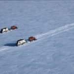 Aerial view of two sno-cats transporting empty drums from Halley Research Station to the ship for crushing and disposal outside Antarctica