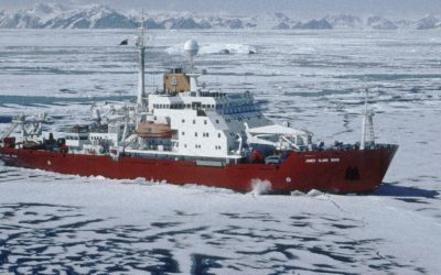 RRS James Clark Ross in pack ice, in Marguerite Bay, close to Rothera research station. The mountains of the Antarctic Peninsula are in the background.