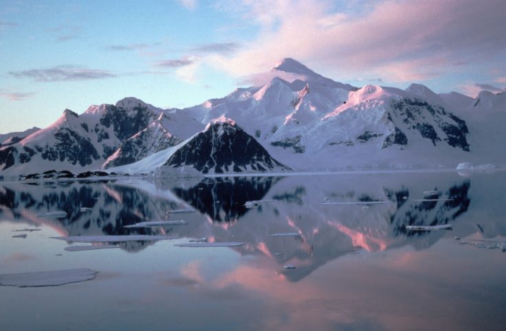 Adelaide Island from Rothera and clouds relectd in a calm sea