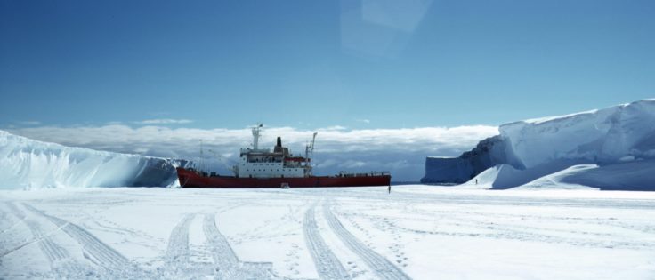 View of the Bransfield anchored at edge of ice cliff, Halley, unloading supplied. (Photographer: Richard Maitland Laws; Archives ref: AD6/19/3/B128)