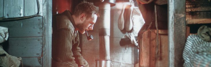 A man standing in front of a wall.