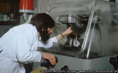 A technician cutting a rock sample for thin section production