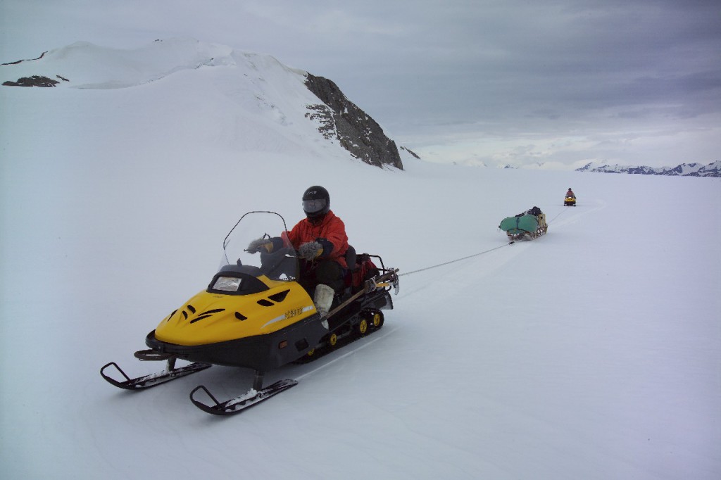 Two-man skidoo team roped together for safe field travel.