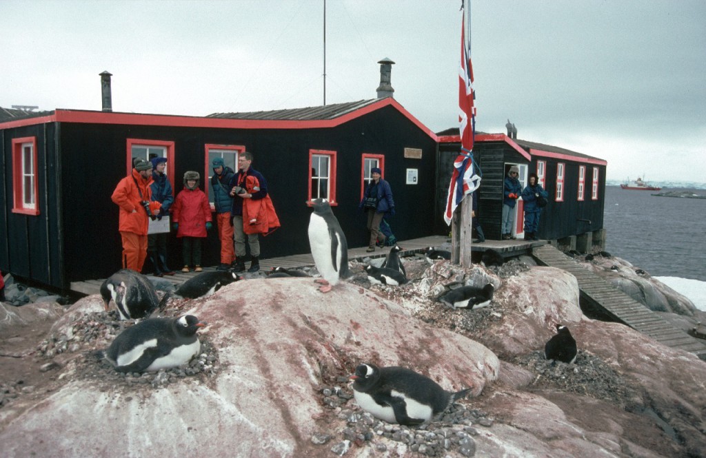 Visitors to the Antarctic Heritage site of Port Lockroy on the Antarctic Peninsula. Port Lockroy was established in 1944 is the only surviving base from Operation Tabarin and is one of the most visited tourist sites in Antarctica.
