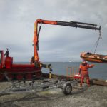 Inflatable boat being lowered into the water at Rothera's wharf. Boat transport allows both marine and terrestrial biologists to investigate sites further from the Station.