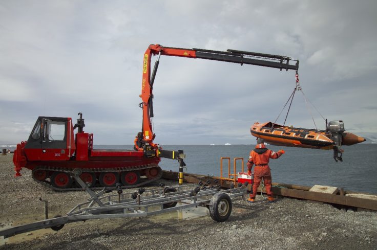 Inflatable boat being lowered into the water at Rothera's wharf. Boat transport allows both marine and terrestrial biologists to investigate sites further from the Station.