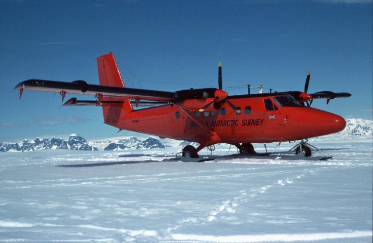 A plane flying over a body of water.