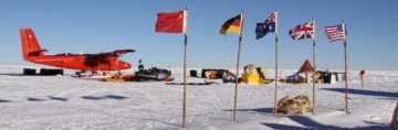 A group of people sitting in the snow.