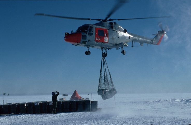 A helicopter flying over a body of water.