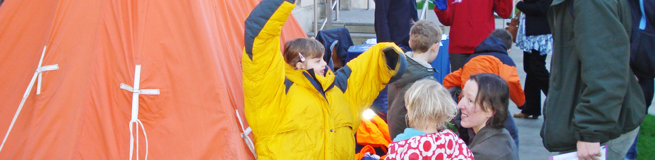 A group of people standing next to a child.