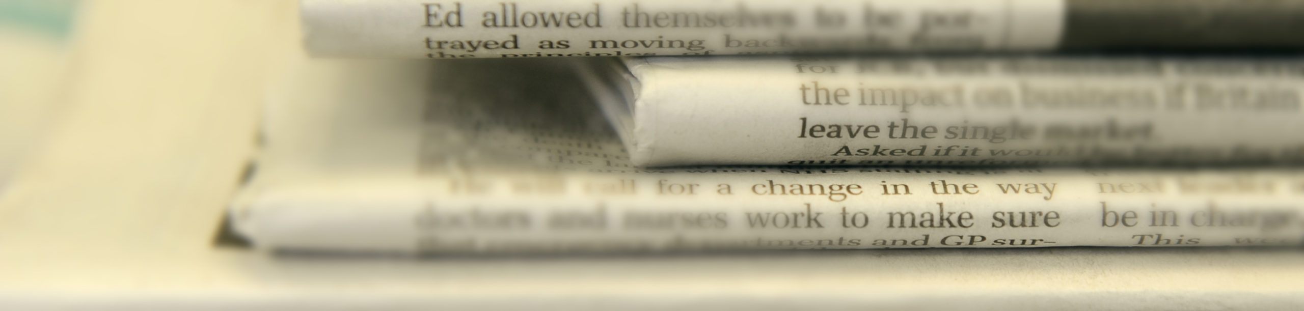 Close up of some stacked up newspapers