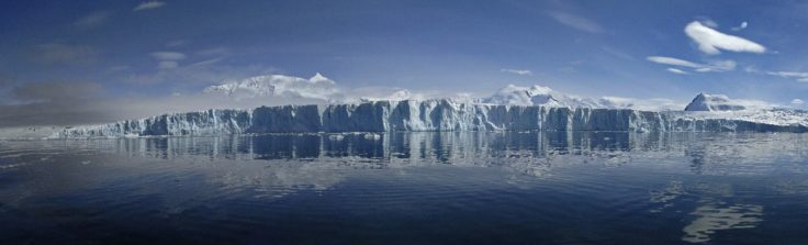 A large body of water with a mountain in the background.