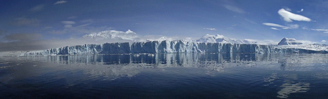 A large body of water with a mountain in the background.