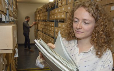 Alysa looking through valuable field party records in the archive at BAS Cambridge