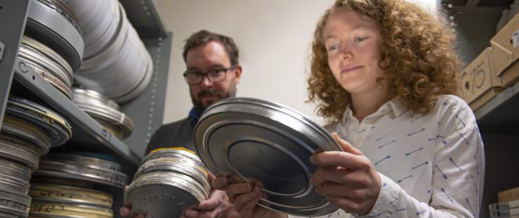 Ieuan and Alysa looking through the valuable film archives in the controlled environment in the archive at BAS Cambridge