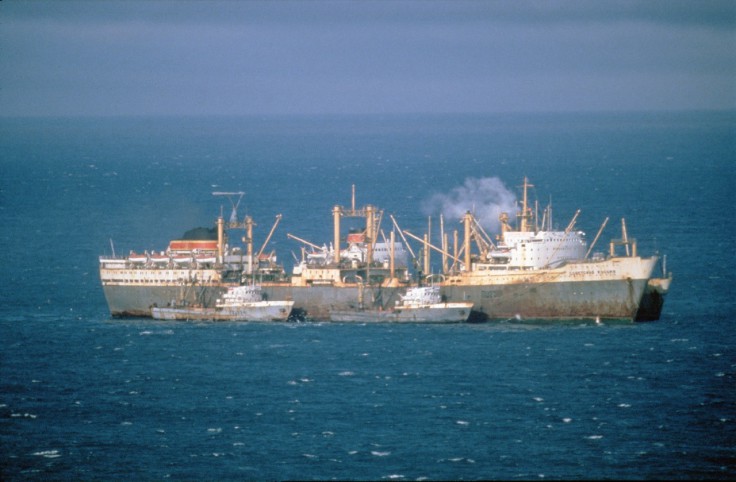 Soviet factory fishing ship (middle) with two trawlers in the foreground and a cargo ship tied behind