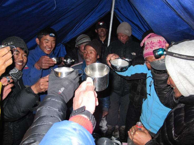 Enjoying a hot mug of chhaang with the guides and porters. 