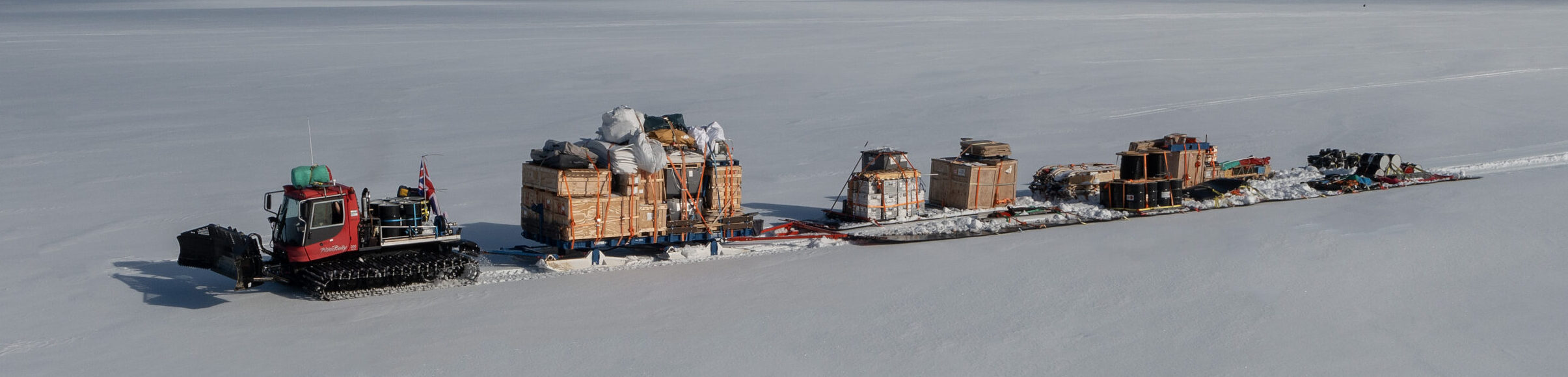 Tractor traverse bring out science cargo and waste from a deep field science drill camp
