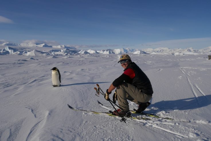 Ashly with an Emperor penguin on the ice (Ashly Fusiarski)