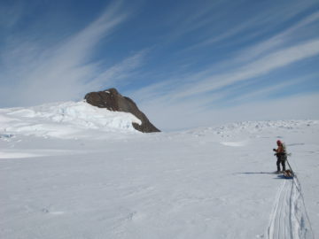 Jo's Field Assistant Iain Rudkin skiing towards Dorrel Rock