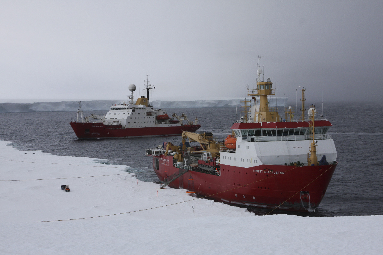 Two large ships at an icy coastline