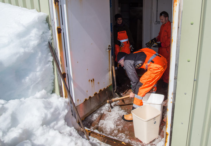 JCR staff helping out with opening up of the base buildings. Here they remove ice from the floor of the food store