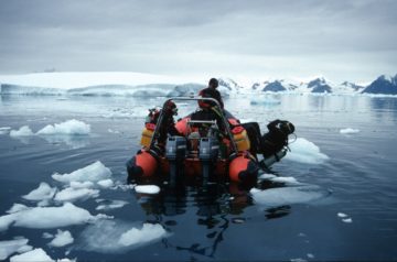 A group of people riding skis on a body of water.