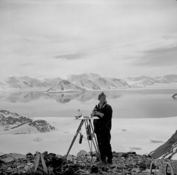 Derek Searle surveying on east side of 'Gendarme Bay', Horseshoe Island, 1956. By 1957, Searle had completely mapped Horseshoe and Lagotellerie Islands, producing a detailed contour map for geology to a scale of 1:25,000.(Archives ref: AD6/19/2/Y4/3; Photographer: Francis Ryan)