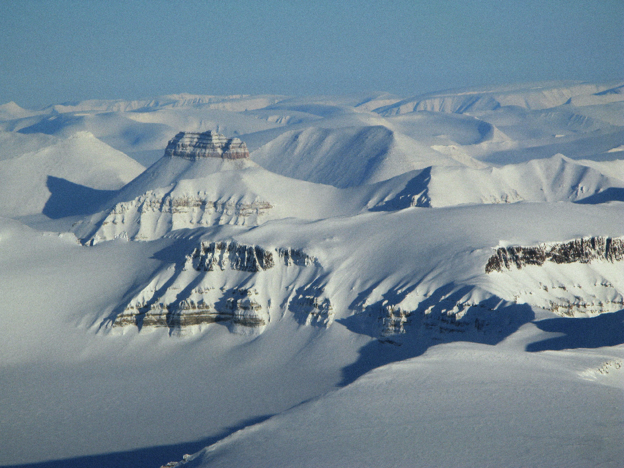 A close up of a snow covered mountain.