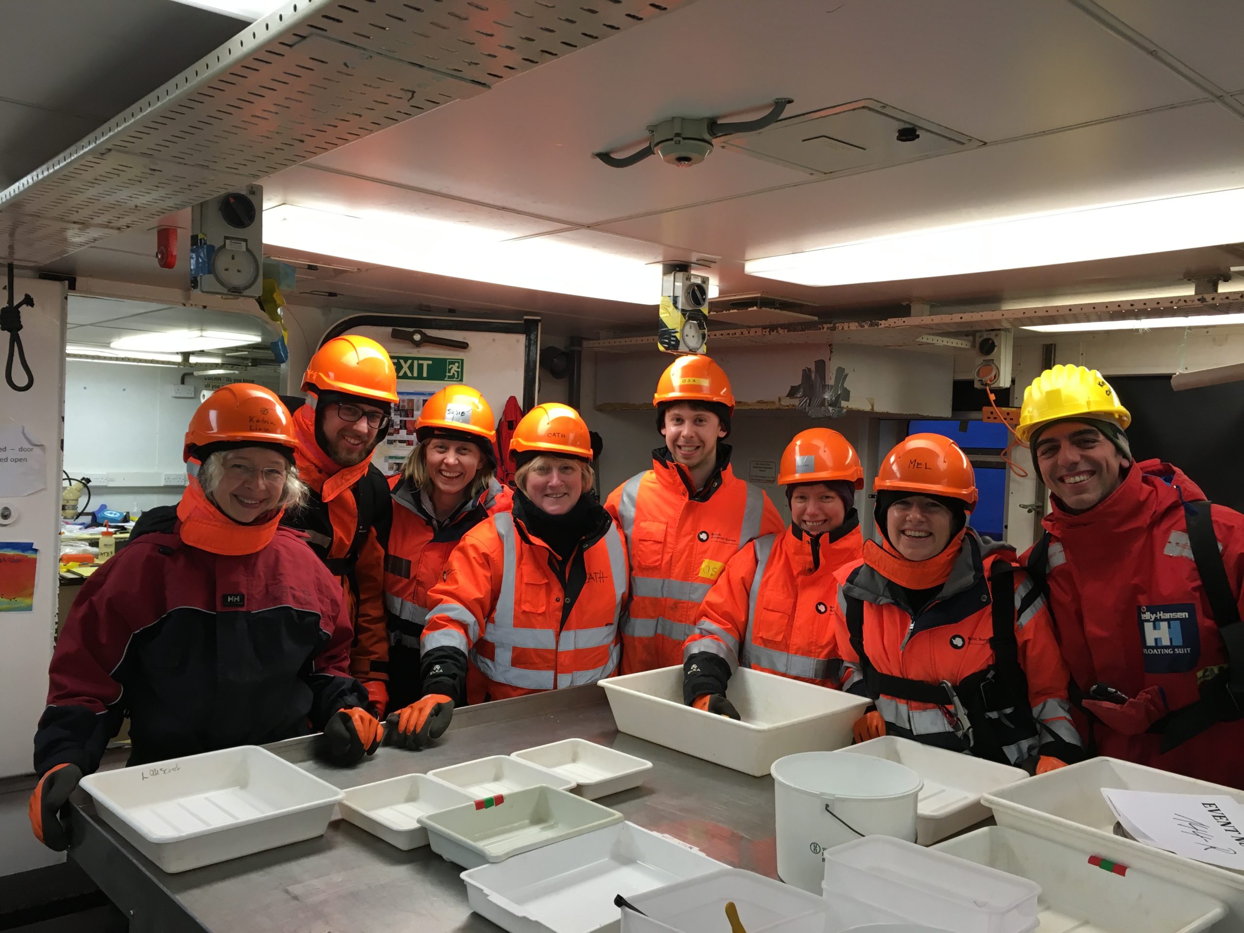 Angelika brandt et al. standing around a table.