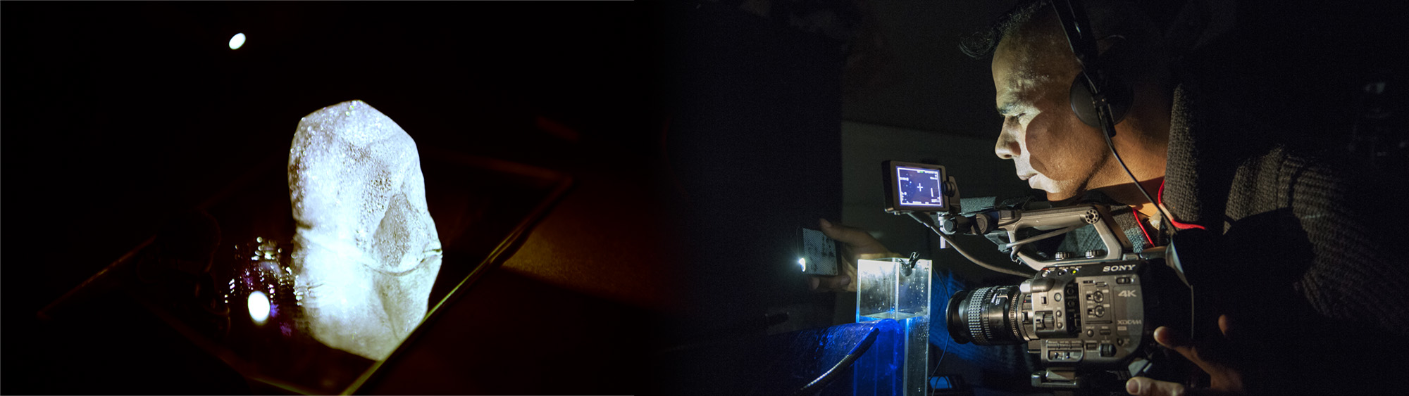 A camera man filming in a dark room.