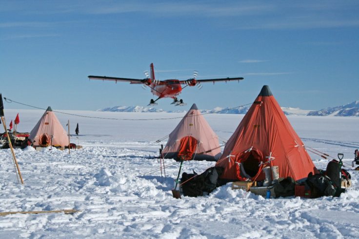 A group of people sitting in the snow.