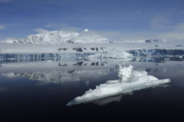 Smoke coming out of a snow covered mountain.