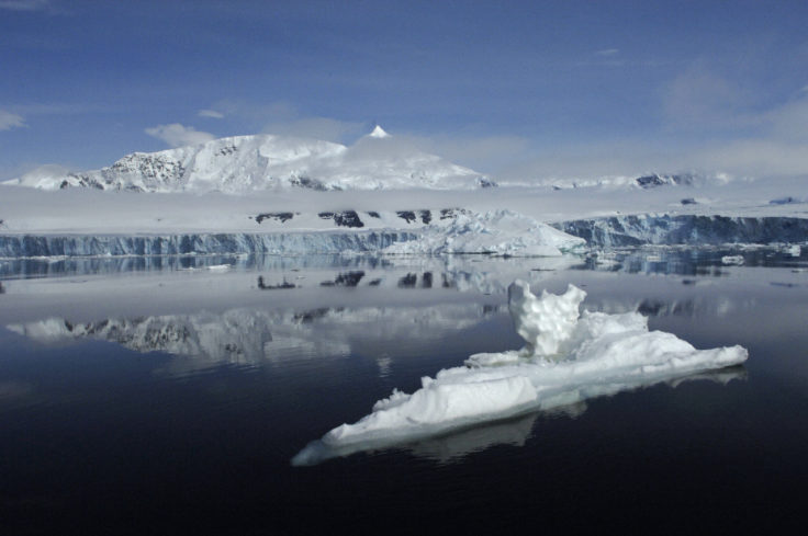 Smoke coming out of a snow covered mountain.