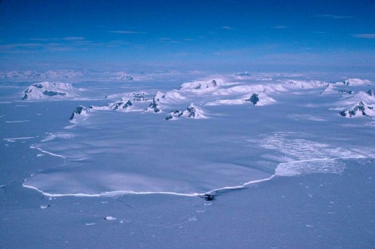 A close up of a snow covered mountain.