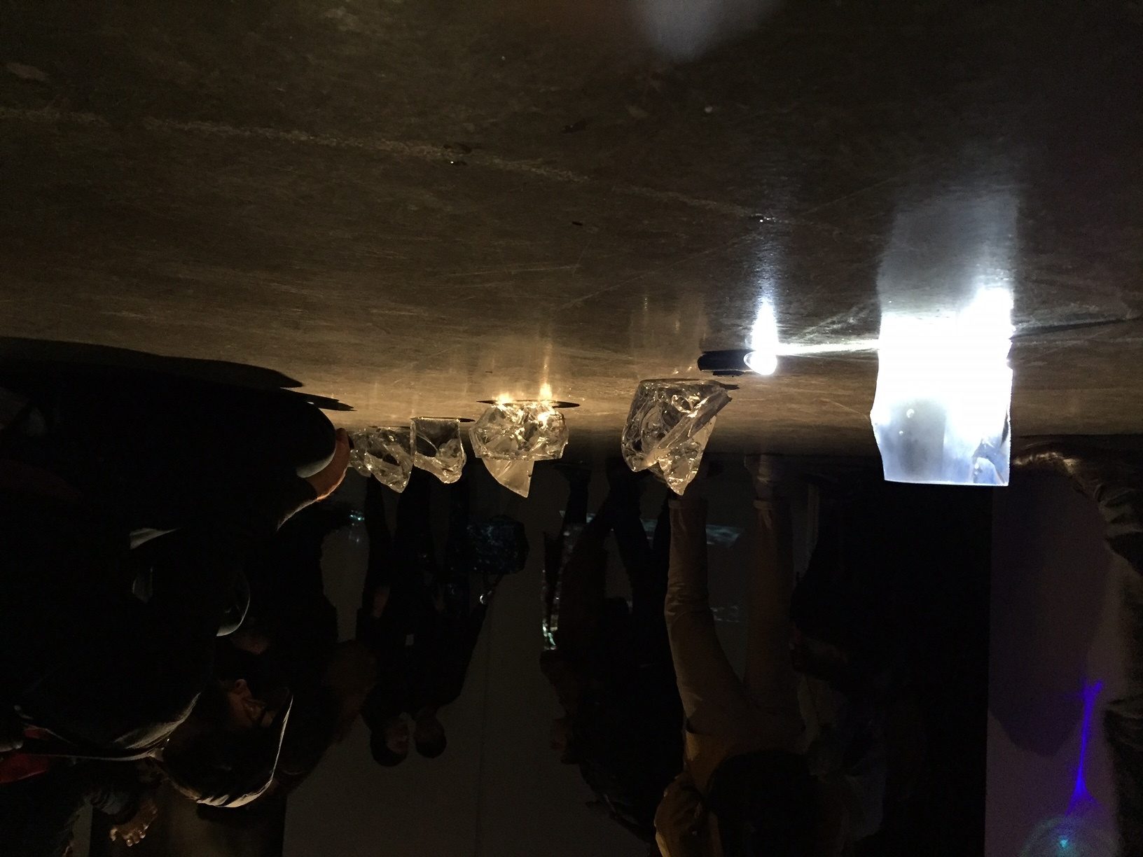 A group of people that are standing in the dark.