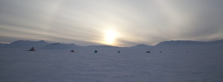 A rainbow over a body of water.