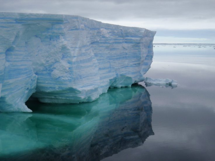 A mountain with water in the background.