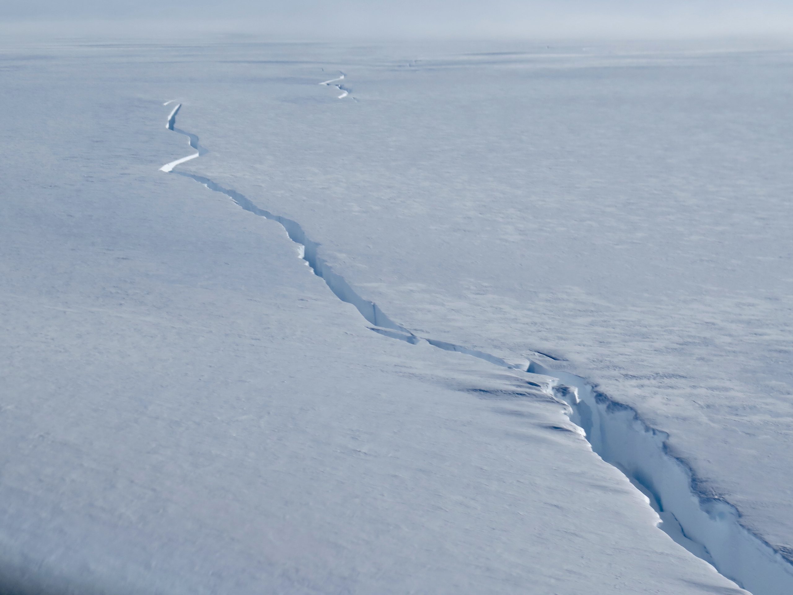 A close up of a snow covered slope.