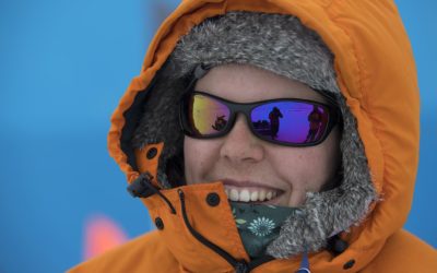 A close up of a person wearing a hat and sunglasses.