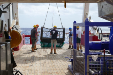 A group of people sitting on a bench.