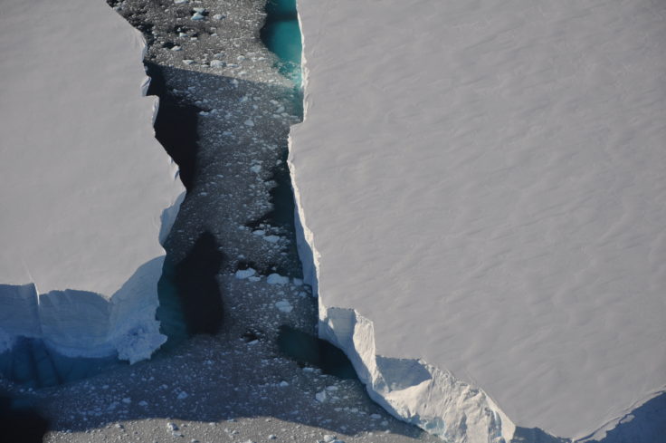 A man flying through the air on a rock.