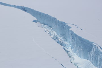 A person riding skis down a snow covered mountain.