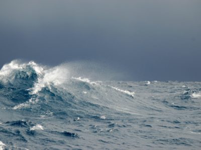 A person riding a wave on top of a mountain.