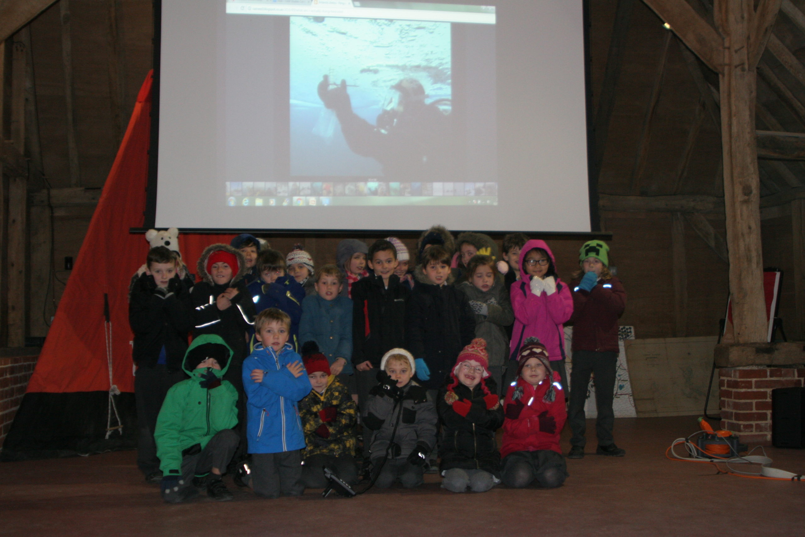 A group of people standing in front of a television.