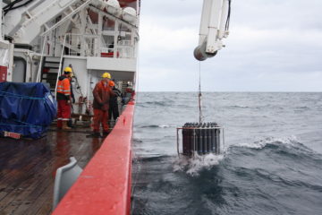 A group of people on a boat in the water.